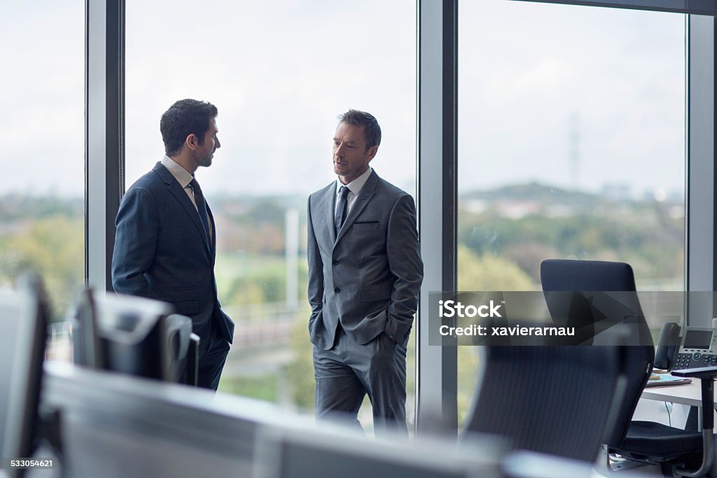 Talking about the company Corporate business people talking about the company situation. Business Stock Photo