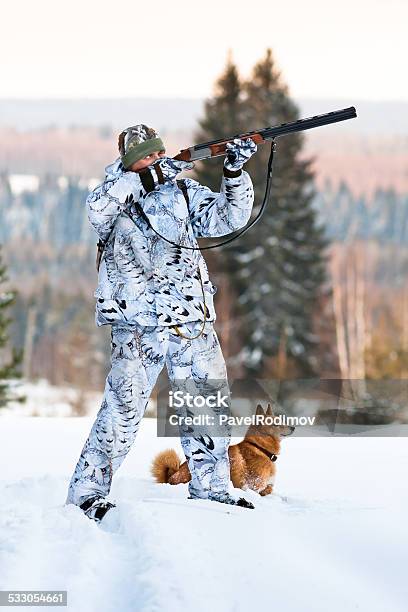 Hunter With Finnish Spitz In Winter Stock Photo - Download Image Now - Finnish Spitz, Hunter, Hunting - Sport