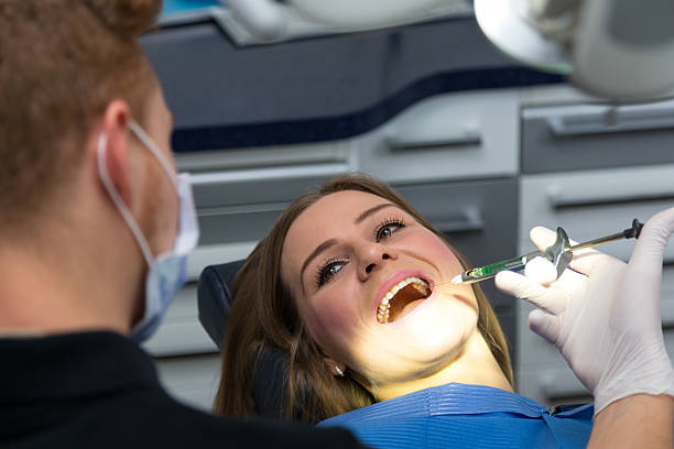 istock Dentist giving a patient anesthetization injection in dental clinic 533055086