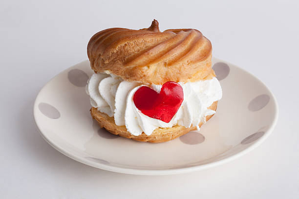 istock cake profiteroles with cream and marmalade heart candy love 533055385