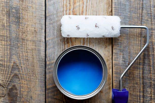 istock painting with  can of blue paint and roller top view 533056568