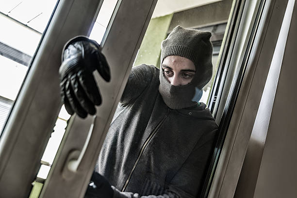 istock Burglar breaking into a house 533057774
