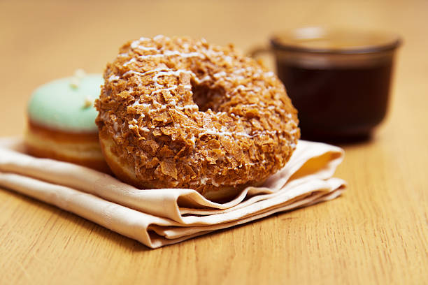 istock donut on a napkin and cup of coffee 533060360