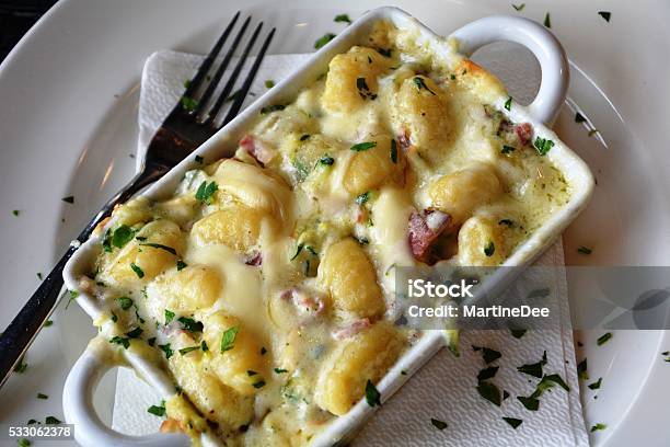 Gnocchi With Parmesan Cheese Baked Stock Photo - Download Image Now - Backgrounds, Basil, Bowl