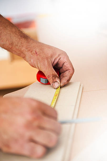 istock Carpenter Measuring a Wooden Plank 533062954