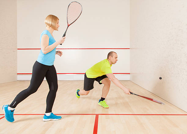 istock young caucasian man and woman playing squash. 533065148