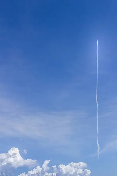 A rocket flying in the sky in the direction of space