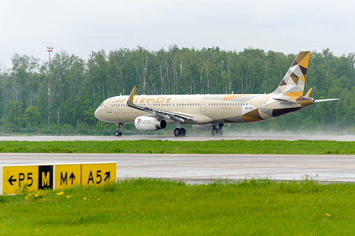 Moscow, Russia - May 19, 2016: Etihad airlines Airbus A321 take off to the runway at Domodedovo International airport.