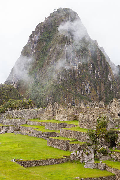 Huayna Picchu, Wayna Picchu or Wayna Pikchu is a mountain behind the majestic ruins of Machu Picchu.  Mist and clouds surround the famous peak. Hiking to the top is allowed.  