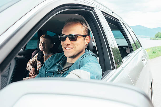 istock Father and son look out from car window 533067776