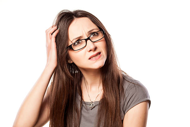 istock Young woman with questionable gesture scraping her hair 533069459