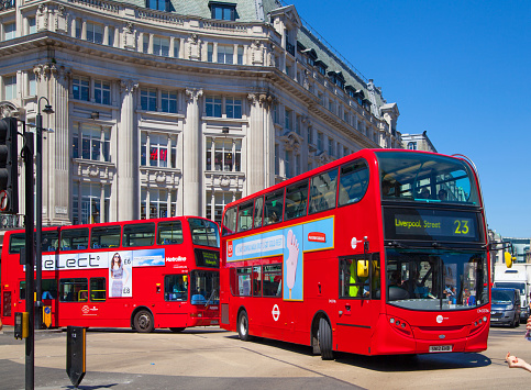 London, UK - July 3, 2014: Regent street busy junction in London, with tourists and red busses