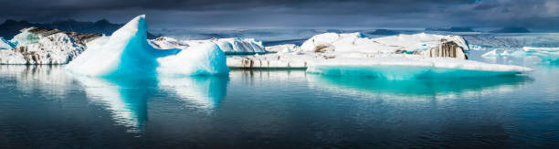 istock Electric blue icebergs floating in Arctic Ocean lagoon panorama Iceland 533070062