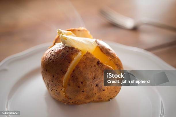 Steaming Hot Baked Potato With Melting Butter Stock Photo - Download Image Now - Baked Potato, Butter, Single Object