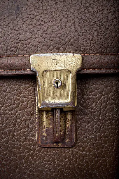 Photo of scratchy lock on used leather shool bag