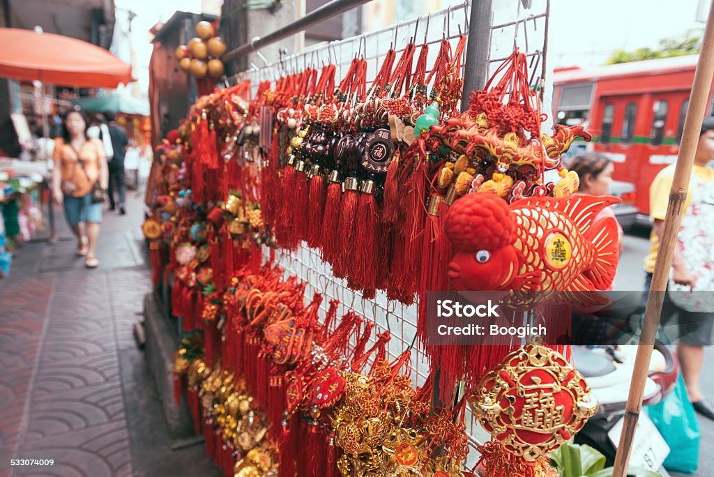 Bangkok Yaowarat Road Chinese Merchandise For Sale in Chinatown Thailand This is horizontal, color photograph of red and gold traditional style Chinese ornamental souvenir merchandise for sale along the sidewalk of Yaowarat Road in Bangkok, Thailand's Chinatown. Photographed during the day with a Nikon D800. Depth of field is shallow. 2015 Stock Photo