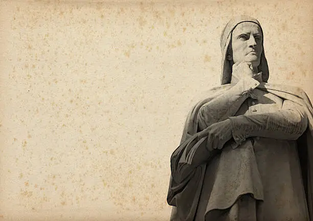 Statue of Dante Alighieri (1265-1321) father of the Italian language on yellowed paper with spots