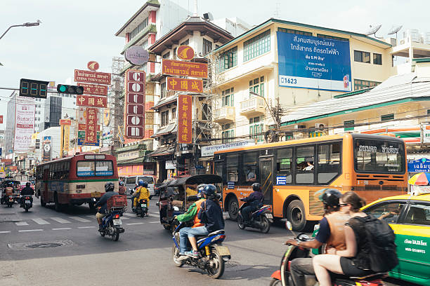 Crowded Bangkok Thailand Yaowarat Road Chinatown Traffic On an overcast day Yaowarat Road in Chinatown is bustling with traffic. Numerous signs hang above. Buses, taxis, tuk tuks, and hired motorbikes drive along the well known street. Photographed with a Nikon D800 on an overcast day. bangkok street stock pictures, royalty-free photos & images