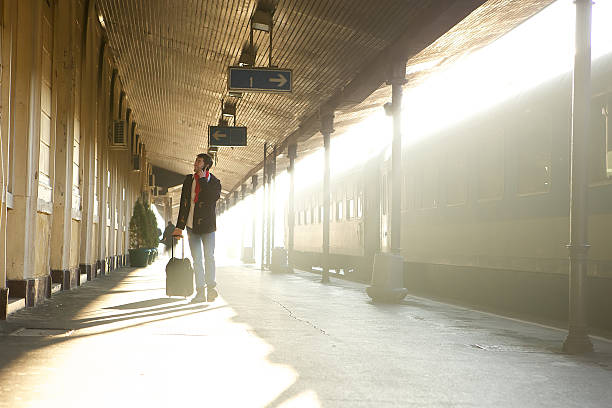 istock Man walking at train station  calling by mobile phone 533131713