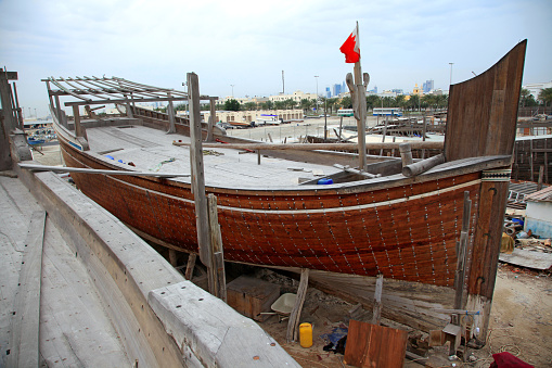 Traditional wooden dhow with bahraini flag