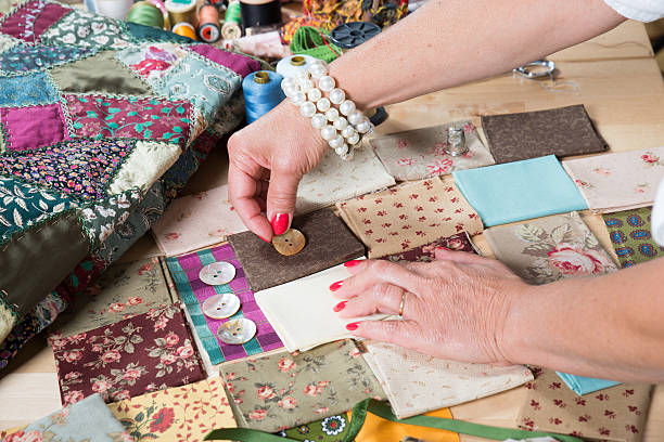 istock Close up of woman's hand sewing patchwork 533134383