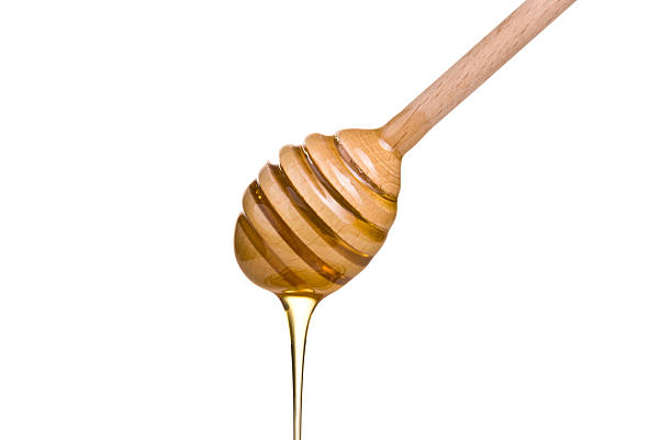 istock honey is dripping from the spoon 533135473