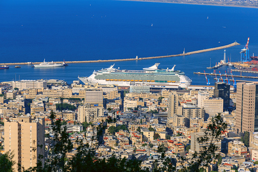 Haifa Israel- September 26, 2011: Seaside town. Daytime Cityscape. Cruise boat waiting in the dock