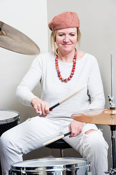 istock Middle-aged blond woman playing a drum kit 533151031