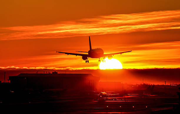 istock Airliner lands to runway late evening sunset 533151437