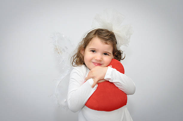 istock Young girl holding a plush red heart 533152595