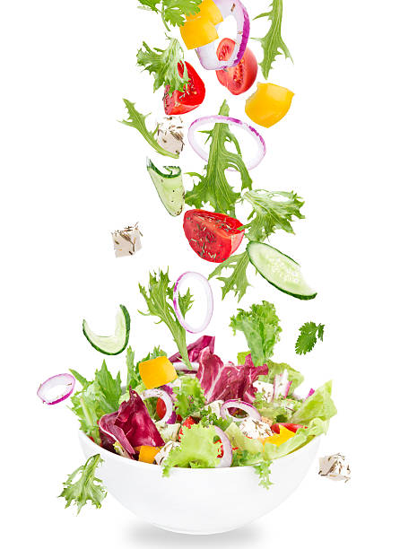 istock Fresh salad with flying vegetables ingredients 533153363