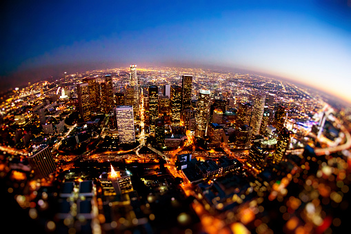 Aerial shot of downtown Los Angeles, CA at night. Photographed with fish-eye lens. Some noise due to low light and high ISO. Shot from R22 helicopter.