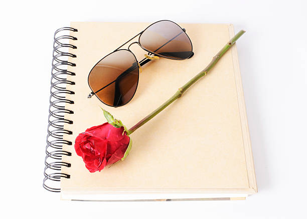 rose withers and sunglasses on book Isolated stock photo