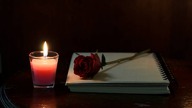 Still life candle and rose flower on book stock photo