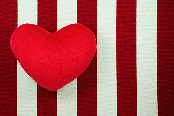 istock Heart on white and red striped fabric background 533174759