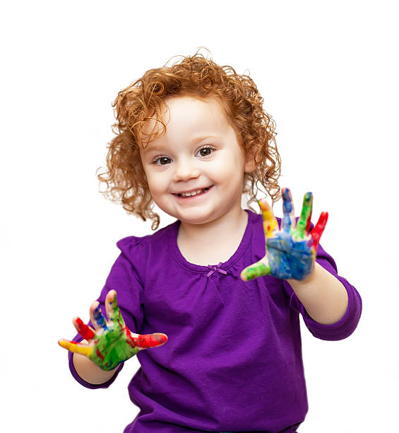 Young Girl in Purple With Paint on Her Hands stock photo