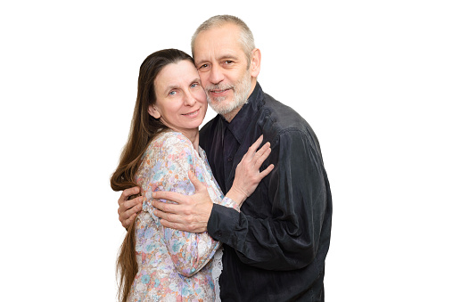Studio portrait of happy seniors couple hugging. Isolated on white background.