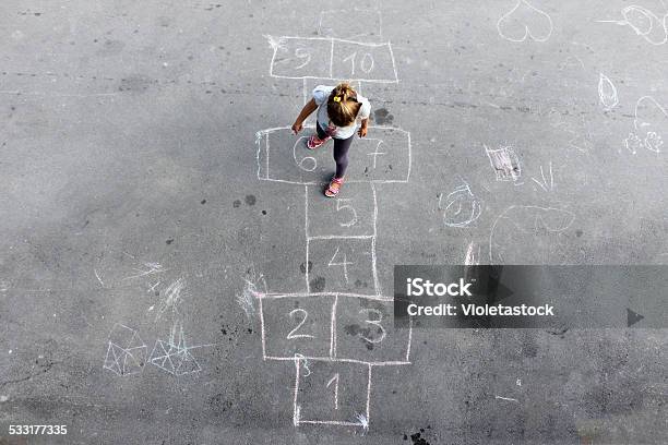 Girl On The Hopscotch Stock Photo - Download Image Now - Child, Schoolyard, Hopscotch
