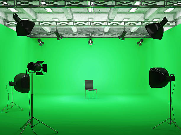 Modern Film Studio with Green Screen and Light Equipment stock photo