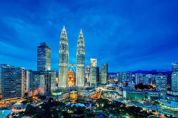 Kuala Lumpur at dusk A cityscape with Petronas towers of the downtown area of Kuala Lumpur, capital city of Malaysia twin towers malaysia stock pictures, royalty-free photos & images