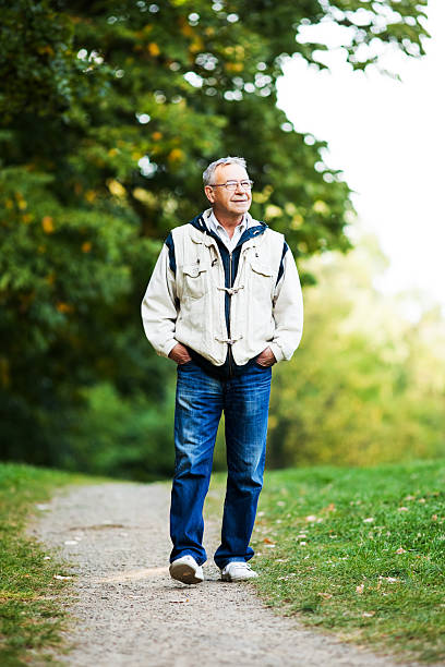 istock Senior man walking in park 533179953