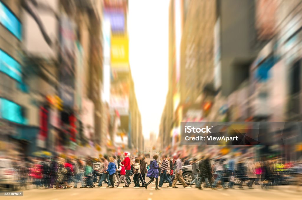 People walking and traffic jam in New York City Manhattan Melting pot people walking on zebra crossing and traffic jam on 7th avenue in Manhattan before sunset - Crowded streets of New York City during rush hour in urban business area - Radial zoom defocusing added during editing Crowd of People Stock Photo