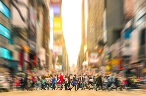 People walking and traffic jam in New York City Manhattan Melting pot people walking on zebra crossing and traffic jam on 7th avenue in Manhattan before sunset - Crowded streets of New York City during rush hour in urban business area - Radial zoom defocusing added during editing times square manhattan photos stock pictures, royalty-free photos & images