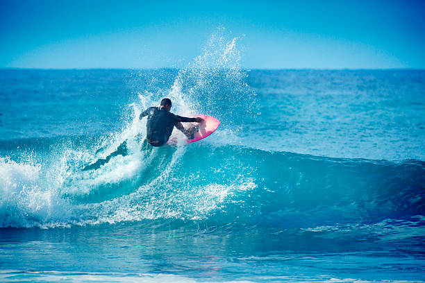 istock Hawaiian Surfer Surfing in Kauai 533189699