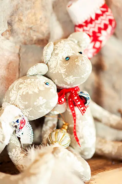 Two handmade provence tilda bear toys on stone wall. Celebration gift. Indoors still-life.