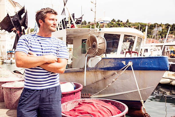 istock fisherman with his fishing boat 533191099