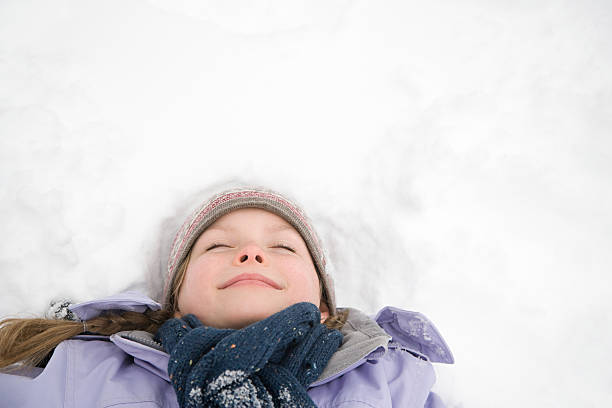 istock Girl lying on snow 533192711