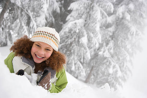 Girl in the snow Girl in the snow snow angel african american stock pictures, royalty-free photos & images