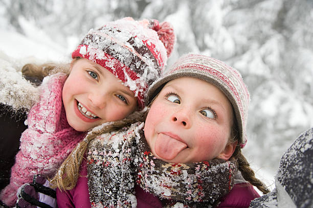 mädchen im schnee - mischief people making a face teenage girls stock-fotos und bilder