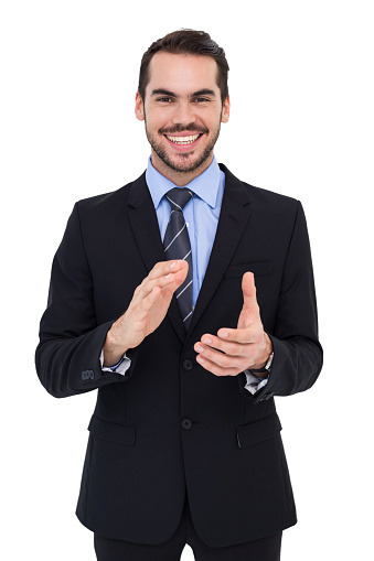 Happy businessman standing and applauding on white background